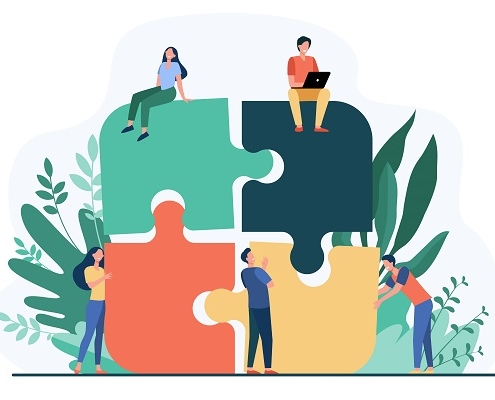 Business team putting together jigsaw puzzle